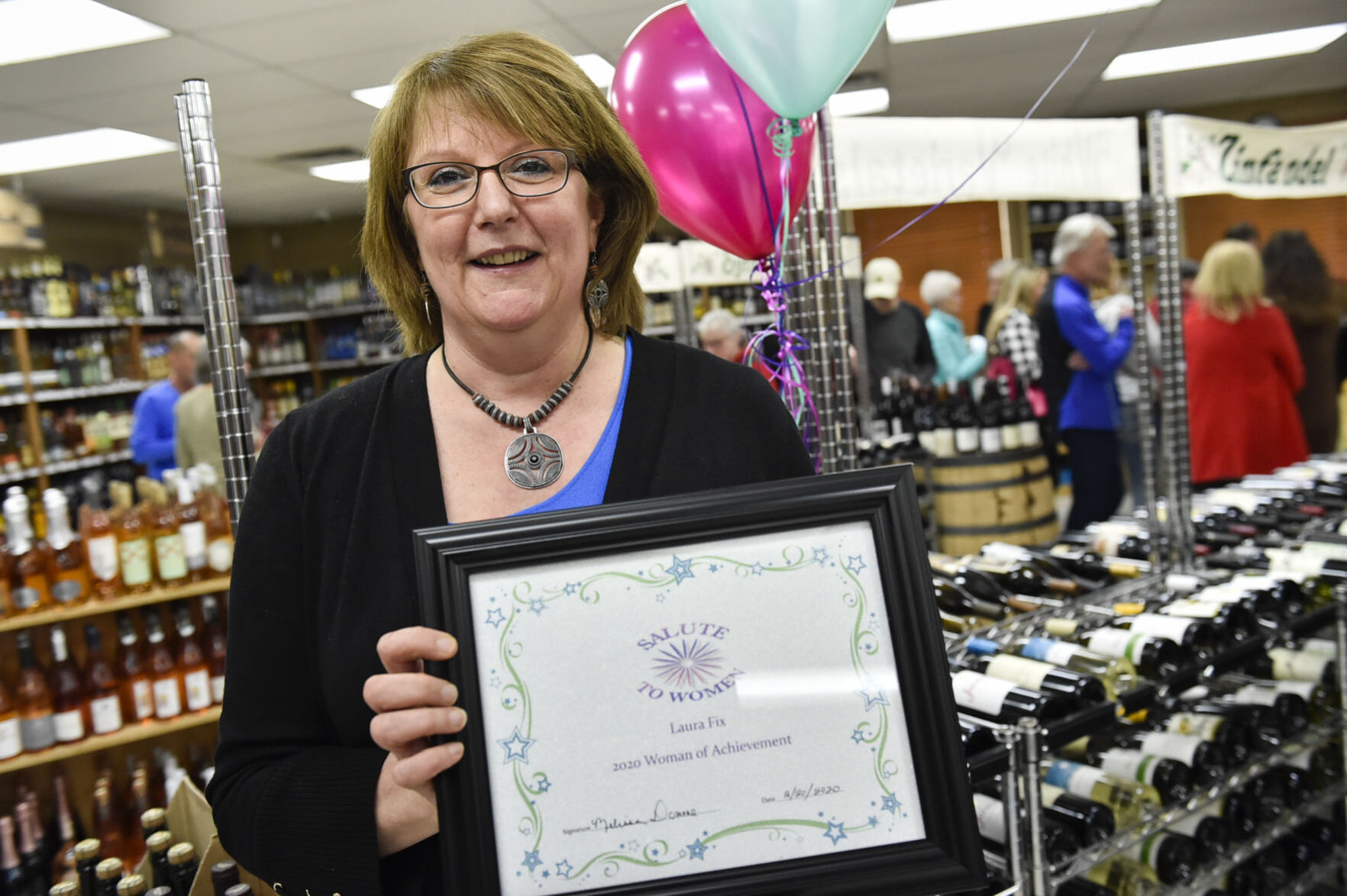 Laura Fix from Island Liquor store receives the Woman of Achievement Award Thursday evening.